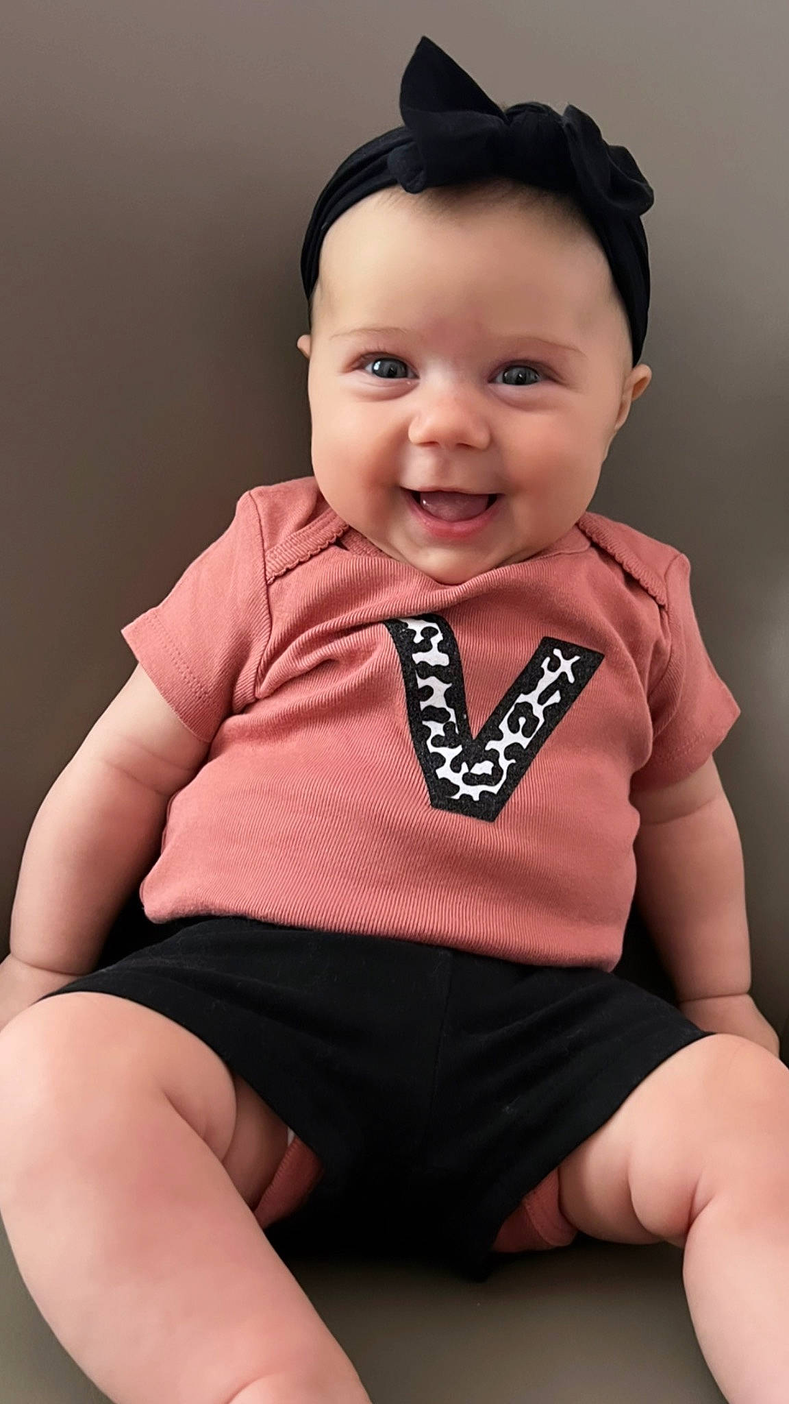 Valentina is registered to the contest to win money with this photo: arm, baby_toddler_clothing, cheek, collar, eye, finger, flash_photography, happy, iris, joy, lip, neck, outerwear, person, pink, shoulder, skin, sleeve, smile, standing