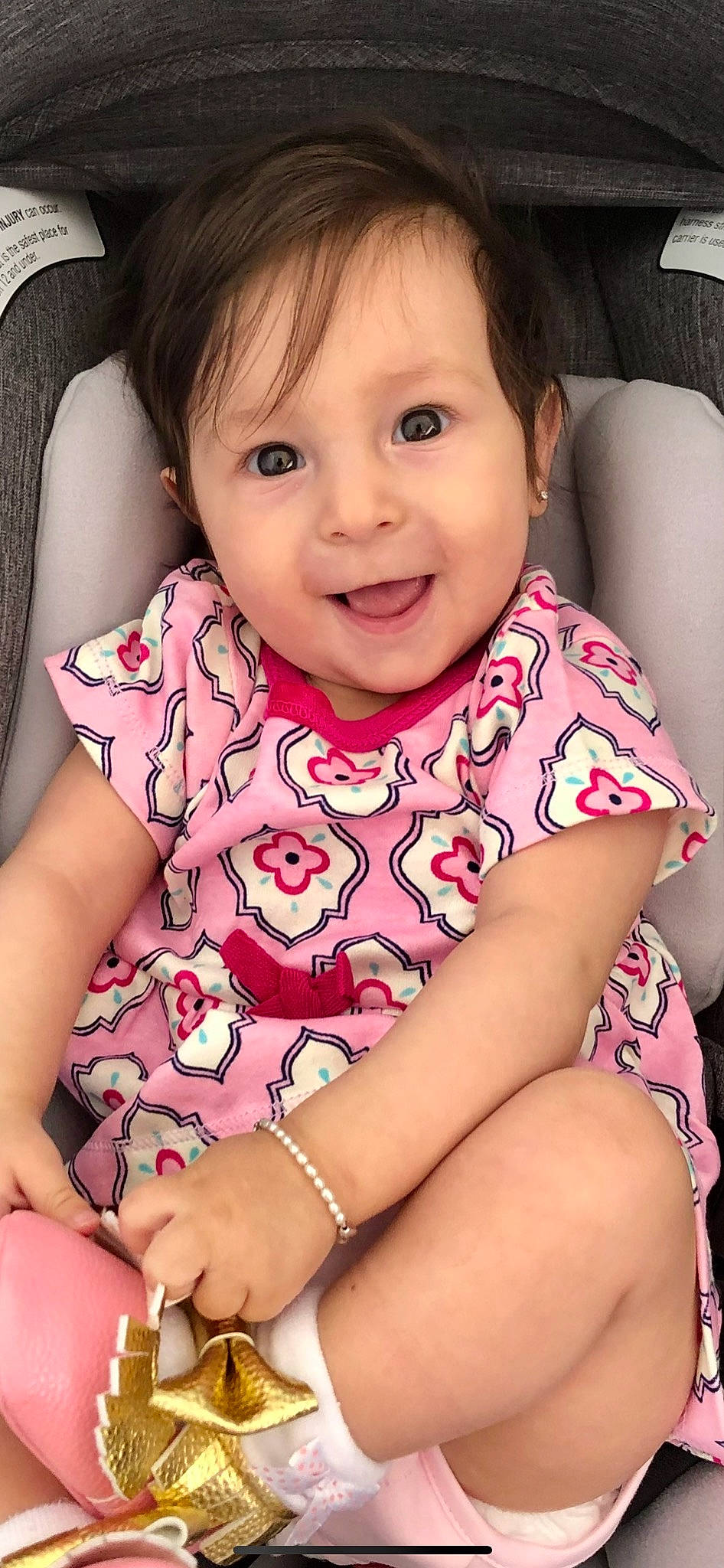 Ilaria is registered to the contest to win money with this photo: arm, baby_toddler_clothing, cheek, chin, eye, eyebrow, eyelash, hairstyle, hand, head, human_body, lip, mouth, neck, nose, organ, person, product, purple, skin