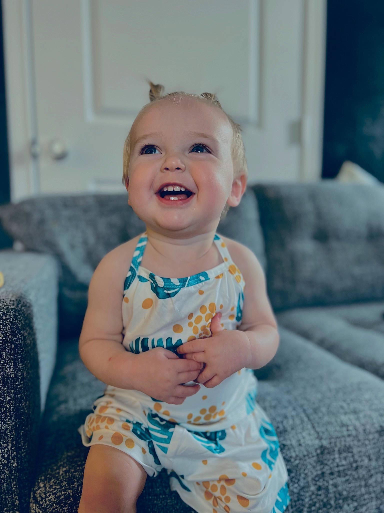 Weslynn is registered to the contest to win money with this photo: aqua, baby, baby_toddler_clothing, blue, cheek, child, couch, dress, eye, face, flash_photography, hair, happy, head, iris, joy, person, pink, purple, skin