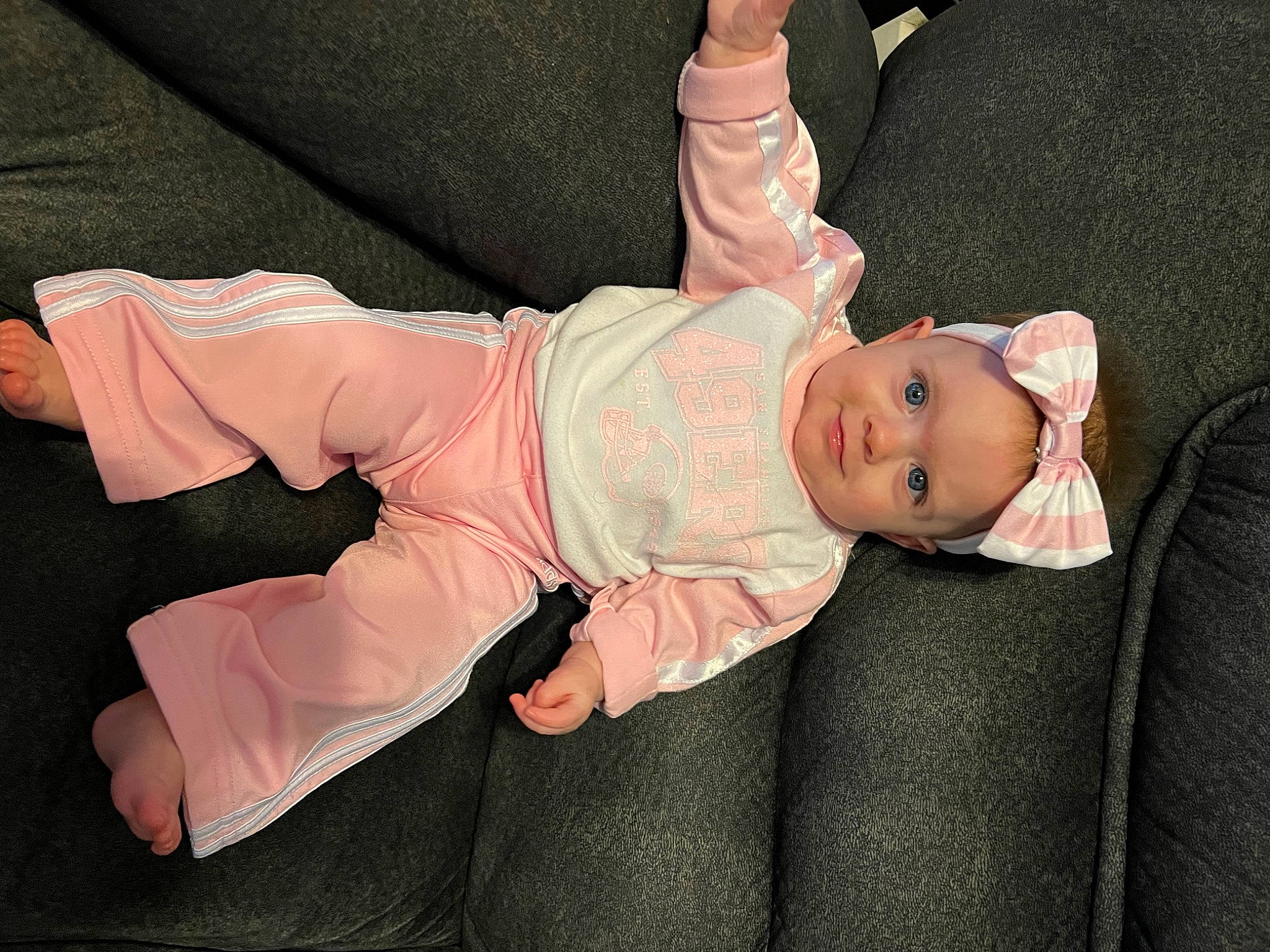 Aurora is registered to the contest to win money with this photo: abdomen, baby, baby_products, baby_toddler_clothing, cheek, child, comfort, event, eye, finger, foot, gesture, hat, headwear, knee, person, sitting, skin, sleeve, thumb