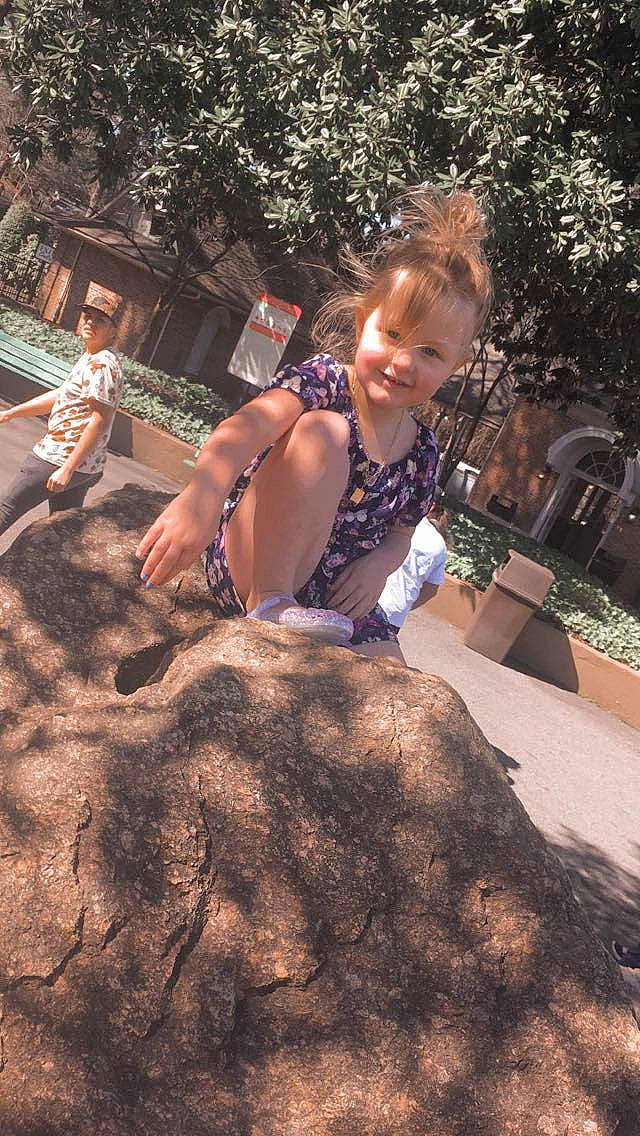 Gracelyn Rose joined the competition — help win amazing prizes! asphalt, city, fawn, flooring, fun, garden, grass, headwear, joy, landscape, leisure, person, plant, recreation, road_surface, sidewalk, sitting, smile, soil, toddler