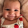 baby, infant, smile, face, eyes, strawberry_pattern, clothing, cute, chubby_cheeks, soft_blanket, closeup, portrait, happy, child, skin, person, head, expression, warm, cozy
