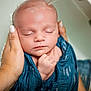 baby, infant, hands, bath, water, blue_cloth, sleeping, peaceful, skin, face, newborn, person, child, closeup, gentle, care, relaxation, tub, parent, serene