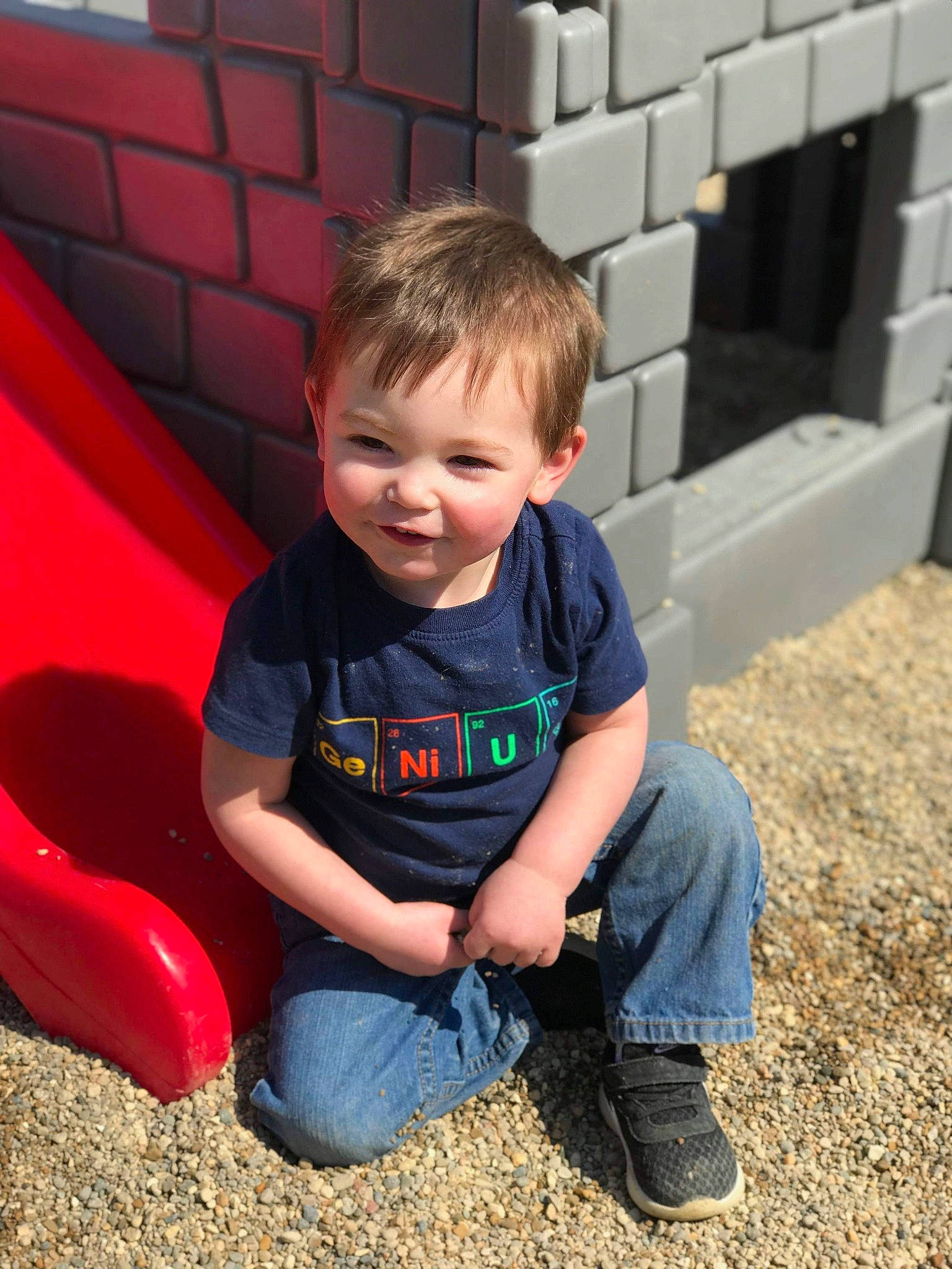 Edward is registered to the contest to win money with this photo: child, fun, male, outdoor_play_equipment, person, play, playground, public_space, recreation, red, sitting, smile, soil, toddler, vacation