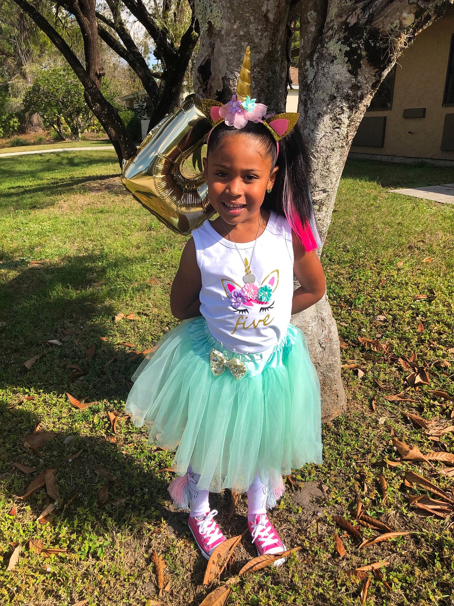 Gloria is registered to the contest to win money with this photo: baby_toddler_clothing, child, clothing, costume, dress, fawn, grass, hair_accessory, joy, person, pink, plant, smile, toddler, tree