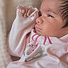 newborn, baby, infant, portrait, close_up, face, eye, nose, mouth, hair, sleepy, pink, clothing, blanket, swaddled, hand, indoor, cozy, toddler, child