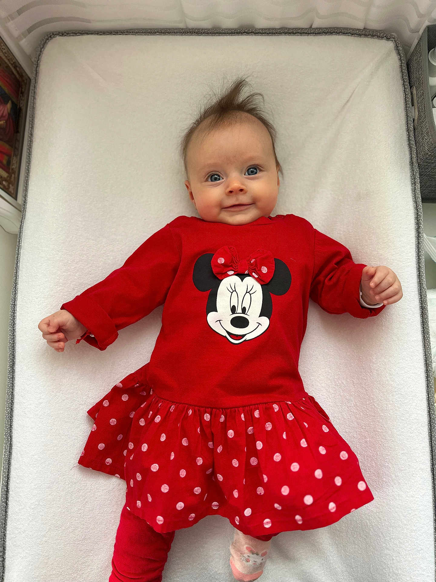 Charlotte a rejoint le concours — aidez-le/la à gagner de superbes lots ! baby, child, smiling, red_dress, minnie_mouse, polka_dots, lying_down, blue_eyes, hair, cute, infant, white_background, clothing, happy, person, portrait, indoors, toddler, playful, apparel