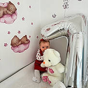 Charlotte participe au concours pour gagner de l'argent avec cette photo : baby, balloon, bed, bunny, child, cute, indoor, infant, number_one, nursery, pacifier, plush, portrait, red_dress, sitting, smile, stars, stuffed_animal, teddy_bear, wallpaper