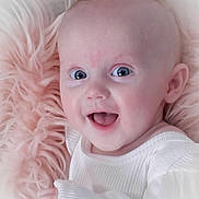 Lila joined the competition — help win amazing prizes! baby, infant, smiling, blue_eyes, white_clothing, soft_blanket, pink_blanket, close_up, happy, cute, child, portrait, skin, head, hand, cozy, young, resting, indoors, comfort