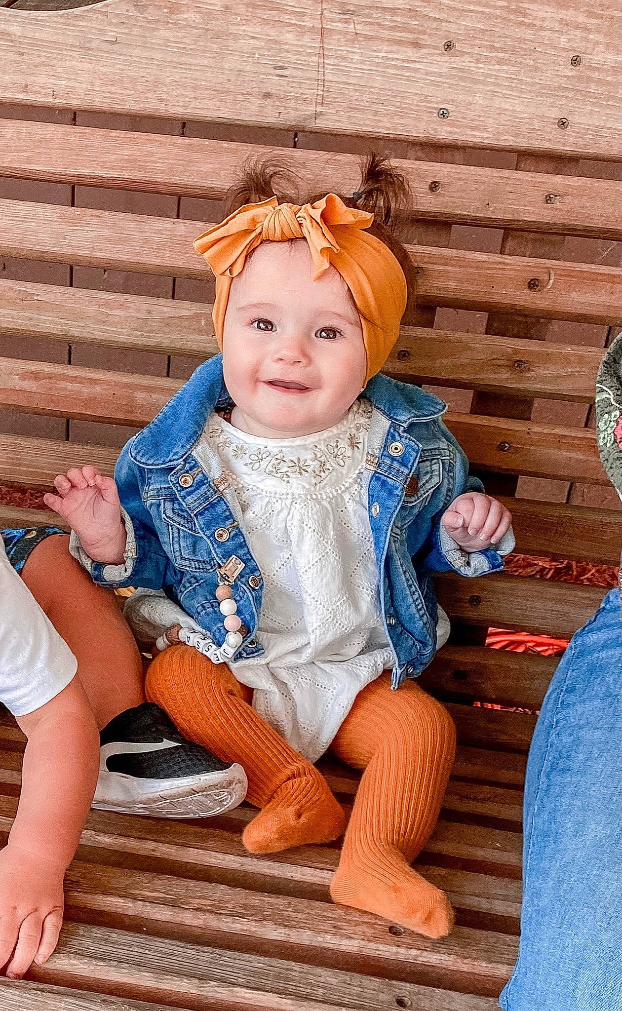 Jessa is registered to the contest to win money with this photo: azure, baby_toddler_clothing, chair, child, eye, fashion_accessory, fun, happy, headband, headpiece, headwear, human_leg, jewellery, joy, orange, pattern, person, sitting, skin, smile