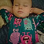 arms, baby, bedtime, blanket, child, colorful_clothing, cozy, cute, face, indoor, monster_design, onesie, pattern, peaceful, portrait, relaxation, rest, sleeping, soft_texture, toddler