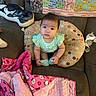 baby, blanket, bottle, child, clothing, couch, cute, face, furniture, green, indoor, infant, person, pillow, pink, polka_dot, quilt, sitting, soft, toy