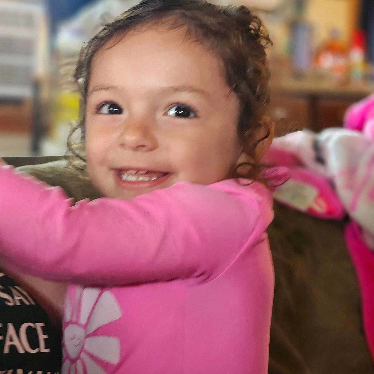 Ellie joined the competition — help win amazing prizes! baby, bodypart, clothing, coat, cushion, face, happy, head, homedecor, indoors, jacket, laughing, mouth, person, photography, portrait, purple, smile, t_shirt, teeth