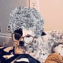 dog, spotted_dog, blanket, glasses, curly_hair_filter, digital_filter, indoor, cozy, resting, furniture, cute, pet, animal, funny, portrait, lying_down, black_and_white_pattern, home, relaxed, toy
