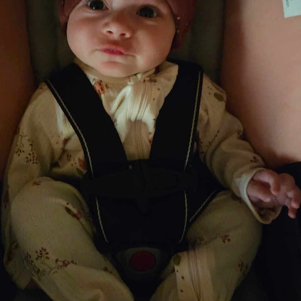 Willow is registered to the contest to win money with this photo: accessories, baby, bonnet, cap, clothing, coat, costume, couch, dress, face, formalwear, furniture, hat, head, jacket, pants, person, photography, portrait, suit