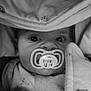 baby, pacifier, blanket, close_up, face, infant, monochrome, portrait, sleepwear, wide_eyes, cute, child, soft_texture, wrapped, cozy, newborn, indoors, clothing, expression, peaceful