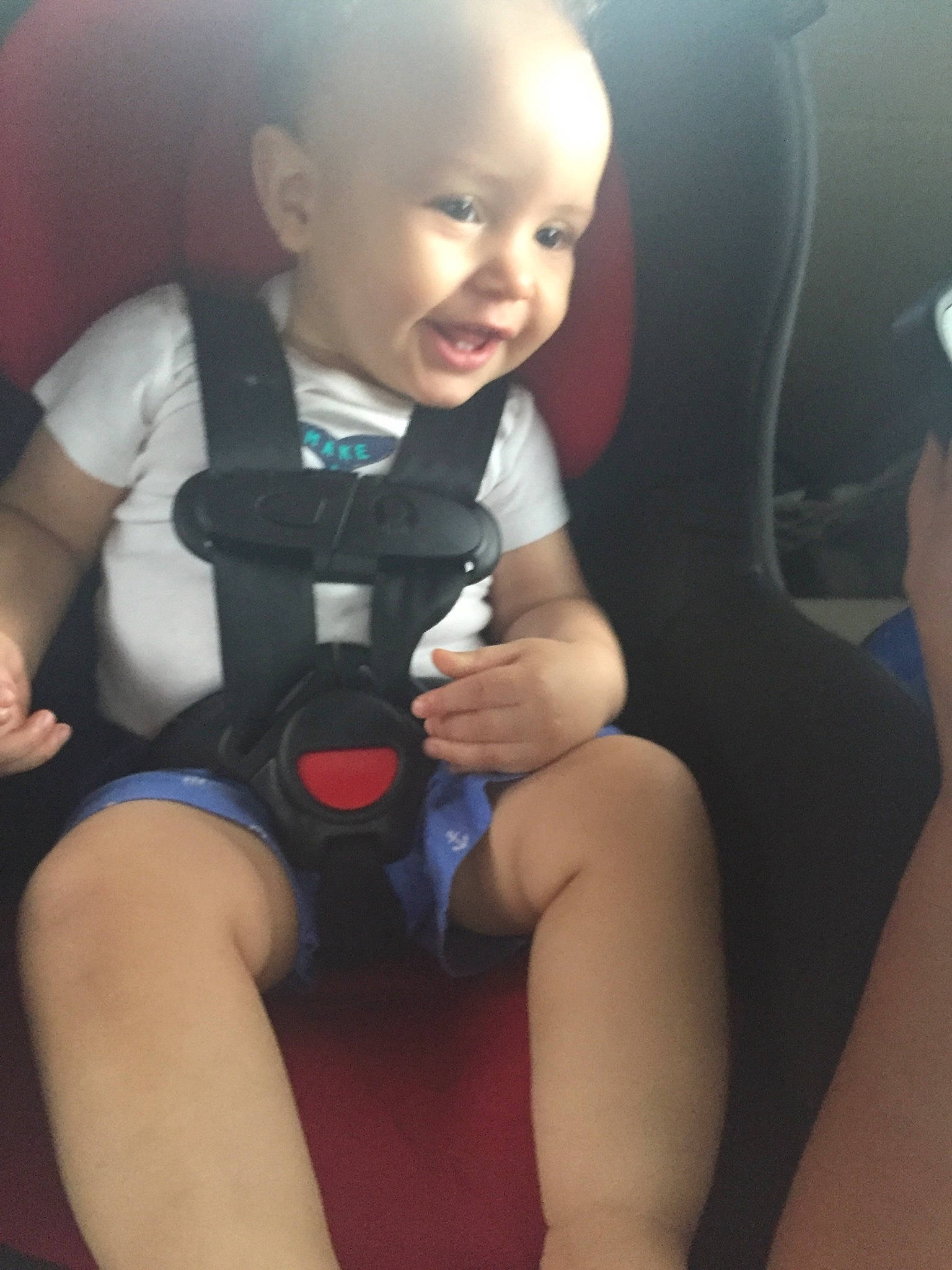 Royal is registered to the contest to win money with this photo: arm, auto_part, baby, car_seat, child, fun, human_leg, joint, knee, leg, neck, person, play, product, sitting, skin, smile, thigh, toddler, vacation