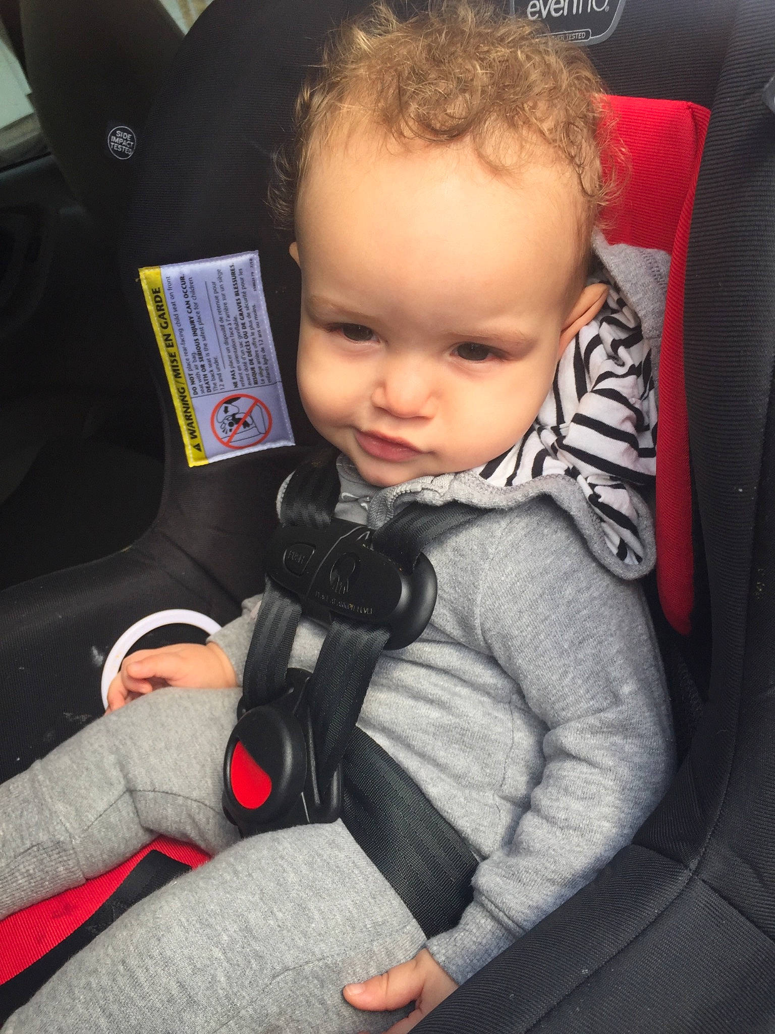 Royal is registered to the contest to win money with this photo: auto_part, baby, baby_in_car_seat, car, car_seat, cheek, child, cool, face, head, person, seat_belt, sitting, skin, toddler