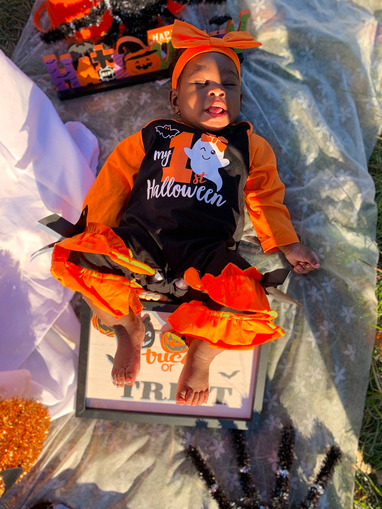 Mackenzie is registered to the contest to win money with this photo: boot, costume, fun, glove, hat, headwear, orange, person, personal_protective_equipment, plant, recreation, shorts, sports_gear, sportswear, t_shirt, tree, trick_or_treat, workwear