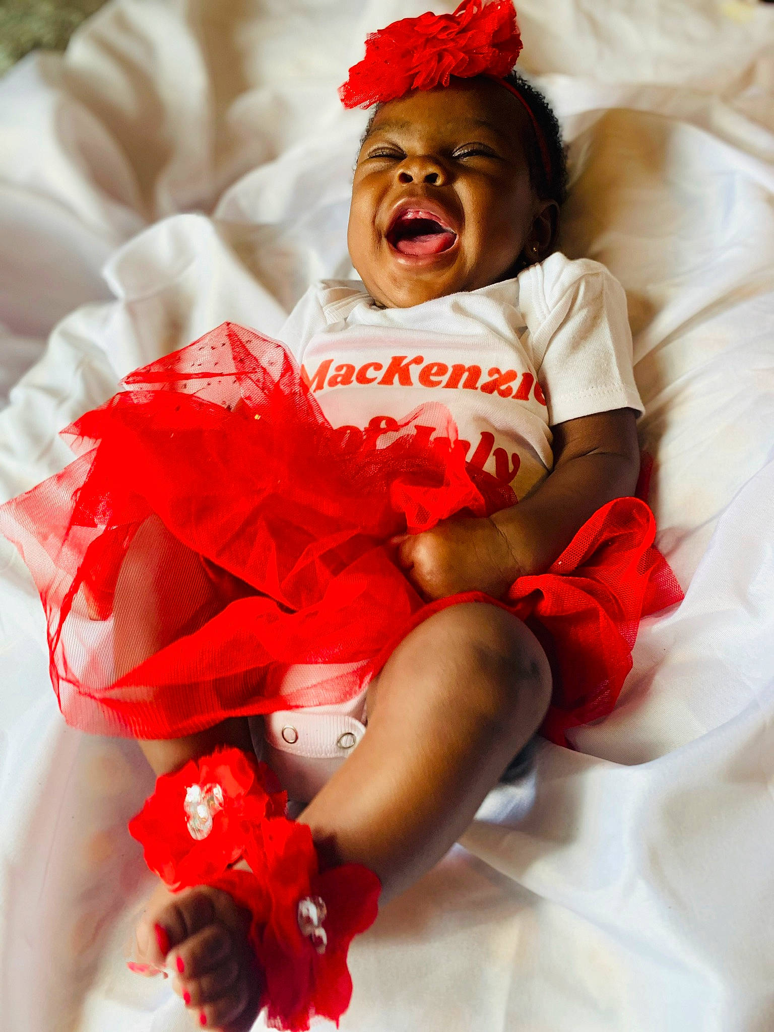 Mackenzie joined the competition — help win amazing prizes! baby, baby_sleeping, baby_toddler_clothing, carmine, child, comfort, event, happy, hat, leg, linens, person, pink, red, sitting, sleeve, smile, textile, thigh, toddler