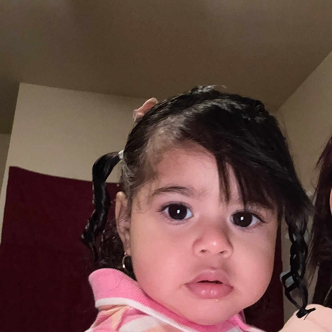 Antonielys is registered to the contest to win money with this photo: baby, big_eyes, child, clothing, curly_hair, cute, earrings, expression, face, hair, head, indoor, person, pigtails, pink, portrait, skin, striped_sweater, toddler, young_child