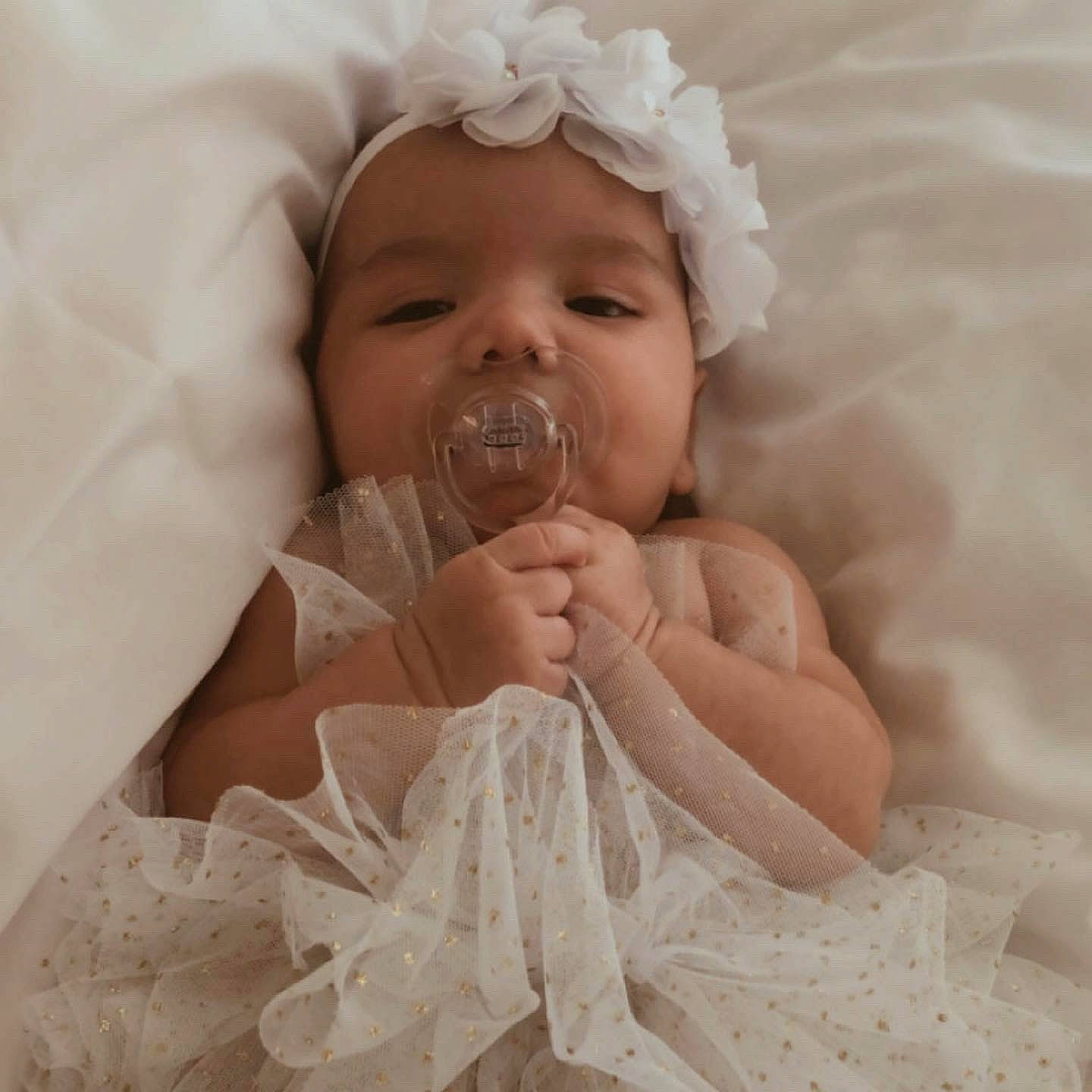 Lorena is registered to the contest to win money with this photo: baby, baby_sleeping, child, dress, eye, finger, hair_accessory, hand, headpiece, linens, nose, person, product, skin, smile, textile, toddler