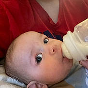 Brantley joined the competition — help win amazing prizes! baby, beverage, bodypart, bottle, couch, cushion, dairy, drinking, face, finger, food, furniture, hand, head, homedecor, milk, newborn, person, photography, portrait