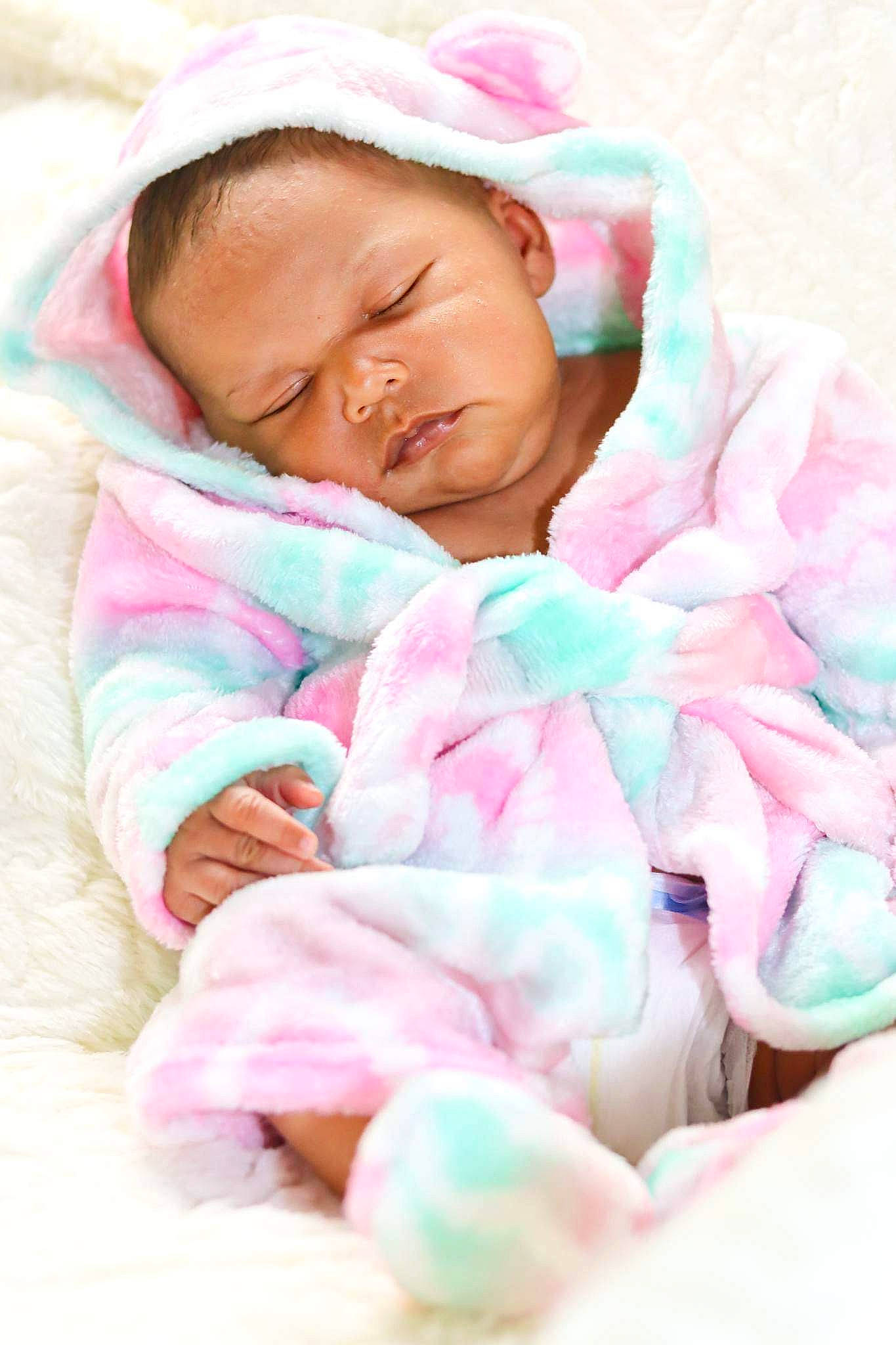Edith is registered to the contest to win money with this photo: baby, baby_products, baby_sleeping, baby_toddler_clothing, bedding, bedtime, cheek, child, comfort, fur, happy, linens, magenta, nap, peach, person, petal, pink, sleep, textile