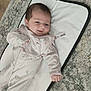 Hallie is registered to the contest to win money with this photo: baby, infant, child, onesie, pink_clothing, lying_down, carpet, mat, indoor, cute, smiling, relaxed, soft_lighting, portrait, young_child, baby_girl, floor, home, sleepy, cozy