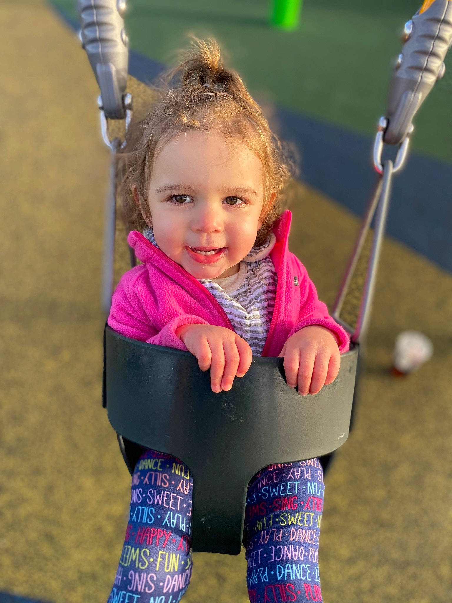 Laurel is registered to the contest to win money with this photo: baby_toddler_clothing, beauty, child, electric_blue, fun, grass, hair, hand, happy, head, human_body, leisure, outdoor_play_equipment, people_in_nature, person, pink, recreation, skin, smile, swing