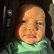 Ethan joined the competition — help win amazing prizes! baby, child, face, green_eyes, close_up, car_seat, sunlight, shadow, mint_green_clothing, ribbed_fabric, expression, infant, protection_label, seat, indoor, portrait, skin, head, person, cute
