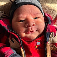 Joao joined the competition — help win amazing prizes! baby, infant, face, clothing, hat, beanie, jacket, red, black, plaid, closeup, skin, cheeks, eyes, sunlight, warm, cozy, cute, child, portrait