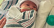 Alaysia is registered to the contest to win money with this photo: newborn, baby, hospital, blanket, swaddled, hat, nasal_tube, medical_equipment, bed, towel, hand, infant, patient, healthcare, care, tiny, wrapped, resting, cute, indoors