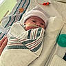 newborn, baby, hospital, blanket, swaddled, hat, nasal_tube, medical_equipment, bed, towel, hand, infant, patient, healthcare, care, tiny, wrapped, resting, cute, indoors