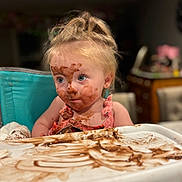 Lilah joined the competition — help win amazing prizes! child, toddler, face_paint, chocolate, messy, highchair, blue_eyes, blonde_hair, indoor, curious, pink_clothing, dining, food, tray, smudged, portrait, cute, baby, eating, fun