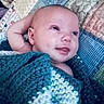 baby, infant, child, smiling, portrait, lying_down, blanket, knitted_blanket, blue, white, bed, bedding, pillow, cozy, indoor, face, eyes, arm, happy, photography