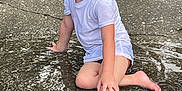David Leland is registered to the contest to win money with this photo: barefoot, boy, child, concrete, curly_hair, face, fun, grass, happy, nature, outdoor, playful, puddle, shorts, sitting, smiling, summer, tshirt, water, wet_clothes