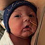 newborn, baby, infant, wrapped, blanket, beanie, feeding_tube, face, closeup, skin, person, hospital, resting, cheek, curious, adult, chest, healthcare, medical, indoors
