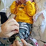 newborn, baby, infant, yellow_shirt, camo_pants, hands, hospital_wristband, blanket, footprint_pattern, sleeping, cute, bed, person, skin, cozy, care, tender, hospital, small_feet, clothing