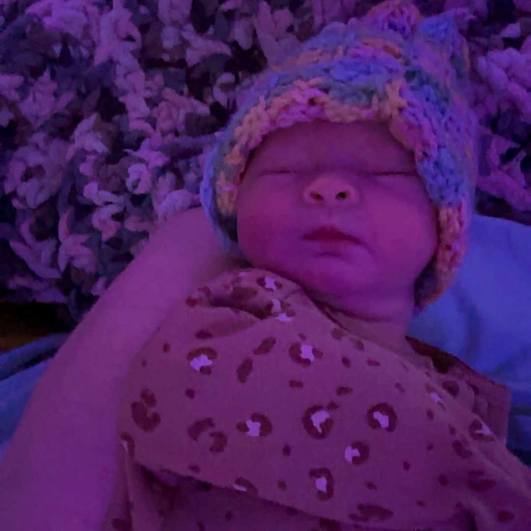 Aurora Linda Renee is registered to the contest to win money with this photo: baby, beanie, blanket, bonnet, cap, clothing, face, flower, glove, hat, head, lady, newborn, person, photography, plant, portrait, purple, quilt, sleeping