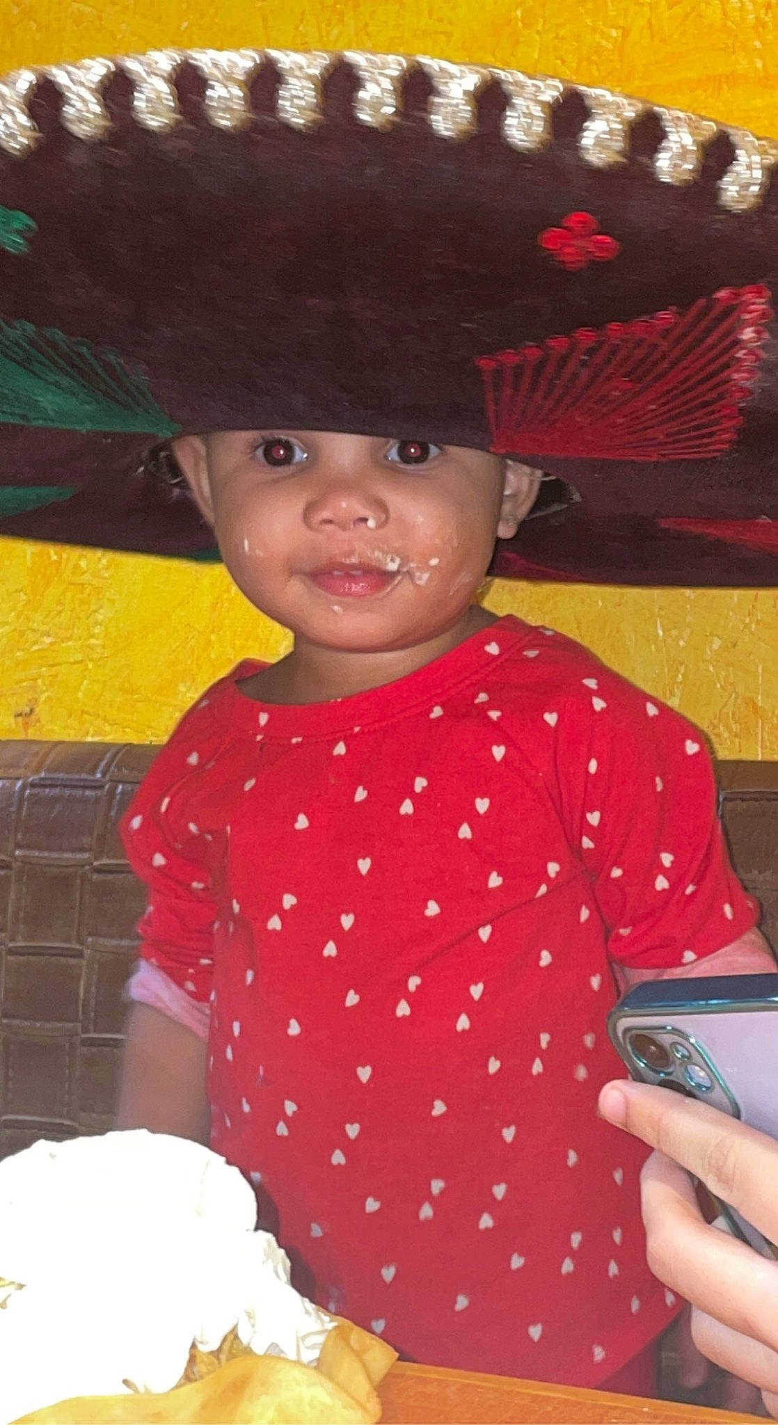 Italeigh is registered to the contest to win money with this photo: baby_toddler_clothing, cap, child, communication_device, costume_hat, dessert, event, fashion_accessory, fun, gadget, happy, hat, headwear, mobile_device, mobile_phone, nail, pattern, person, portable_communications_device, sun_hat