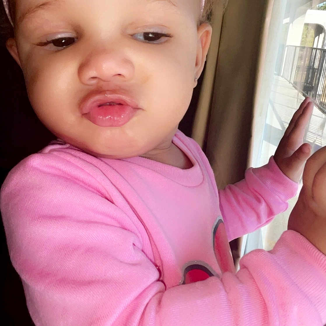 Italeigh is registered to the contest to win money with this photo: arm, baby, baby_toddler_clothing, cheek, elbow, eyelash, finger, fun, gesture, hand, happy, lip, magenta, nail, neck, nose, pink, skin, thumb, toddler