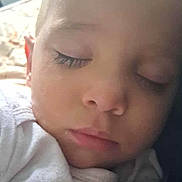 Vani Robert is registered to the contest to win money with this photo: baby, child, close_up, clothing, cute, eyelashes, face, head, indoors, infant, peaceful, portrait, rest, skin, sleep, sleeping, soft_light, text, white, young_child