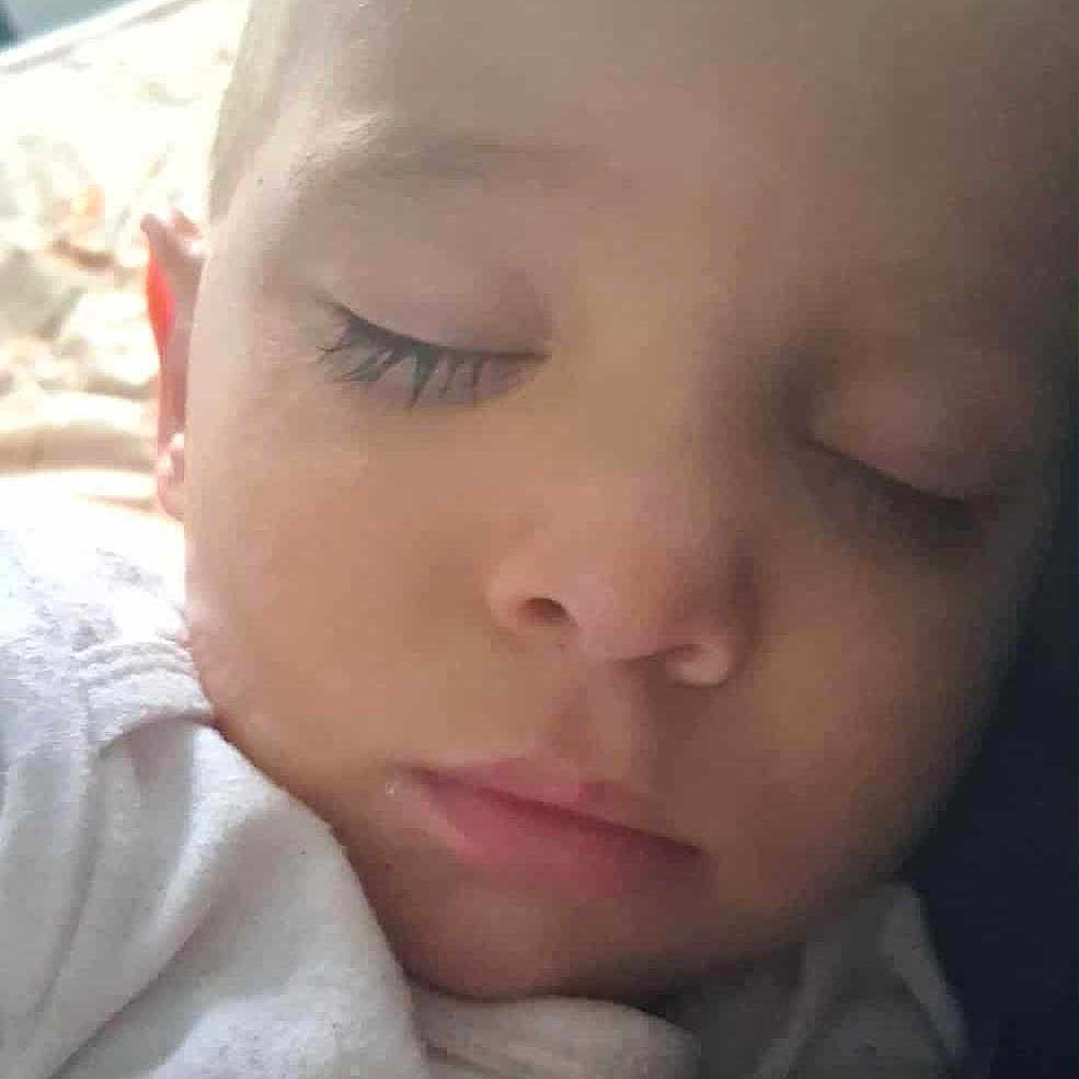 Vani Robert is registered to the contest to win money with this photo: baby, child, close_up, clothing, cute, eyelashes, face, head, indoors, infant, peaceful, portrait, rest, skin, sleep, sleeping, soft_light, text, white, young_child