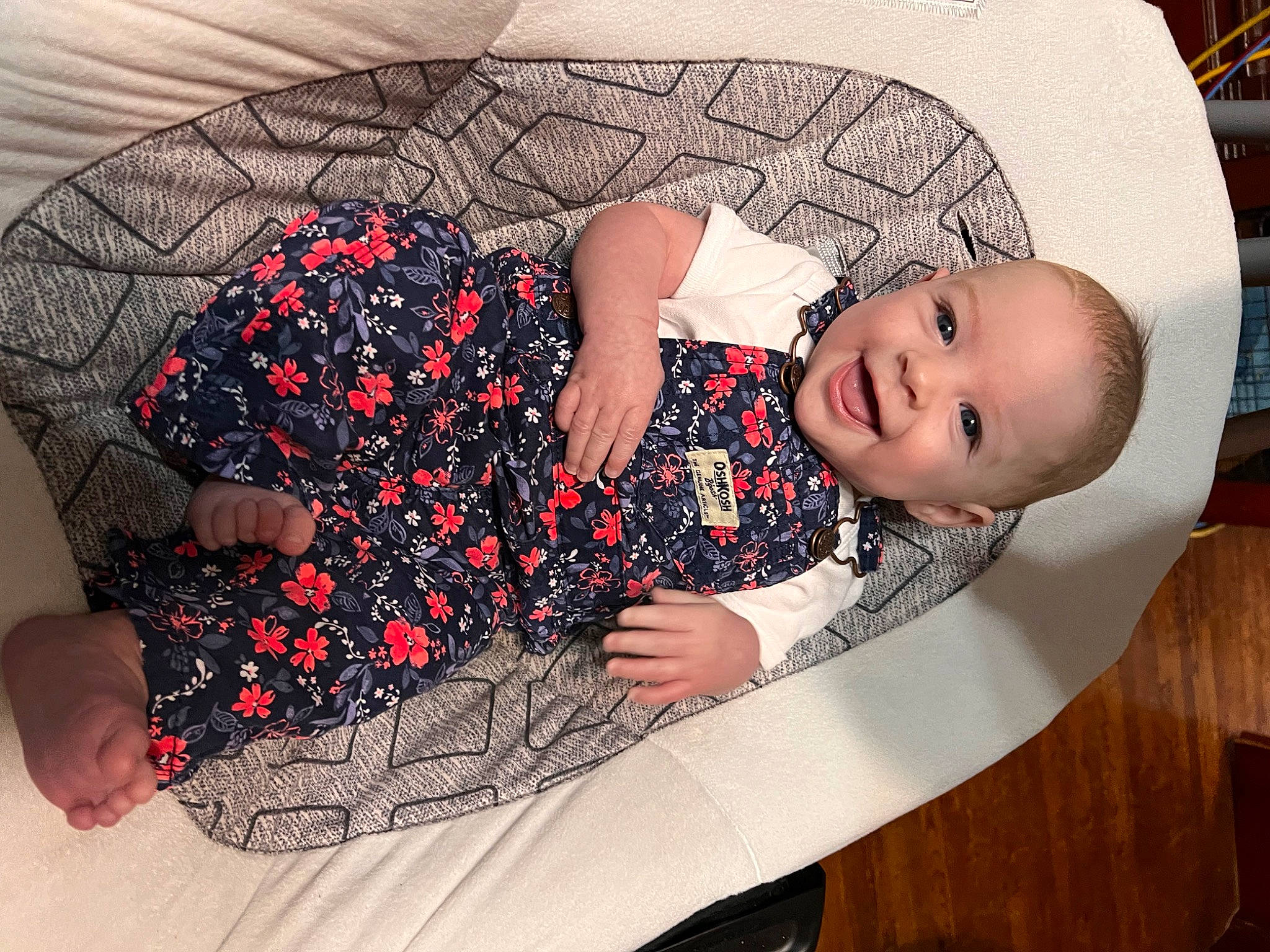 Rylin is registered to the contest to win money with this photo: baby, baby_products, baby_safety, baby_sleeping, baby_toddler_clothing, bookcase, carmine, child, comfort, fashion_accessory, flooring, fun, human_leg, linens, pattern, person, room, sitting, thigh, toddler