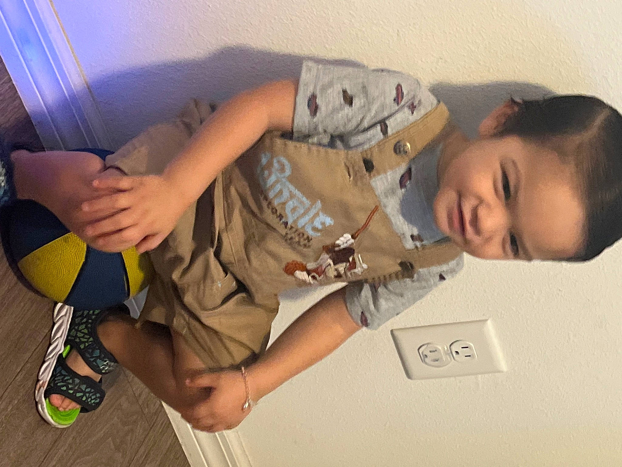 Niko is registered to the contest to win money with this photo: arm, child, comfort, elbow, eyewear, finger, flooring, fun, hand, human_leg, joint, knee, leg, person, personal_protective_equipment, sandal, shoe, sneakers, thigh, toddler