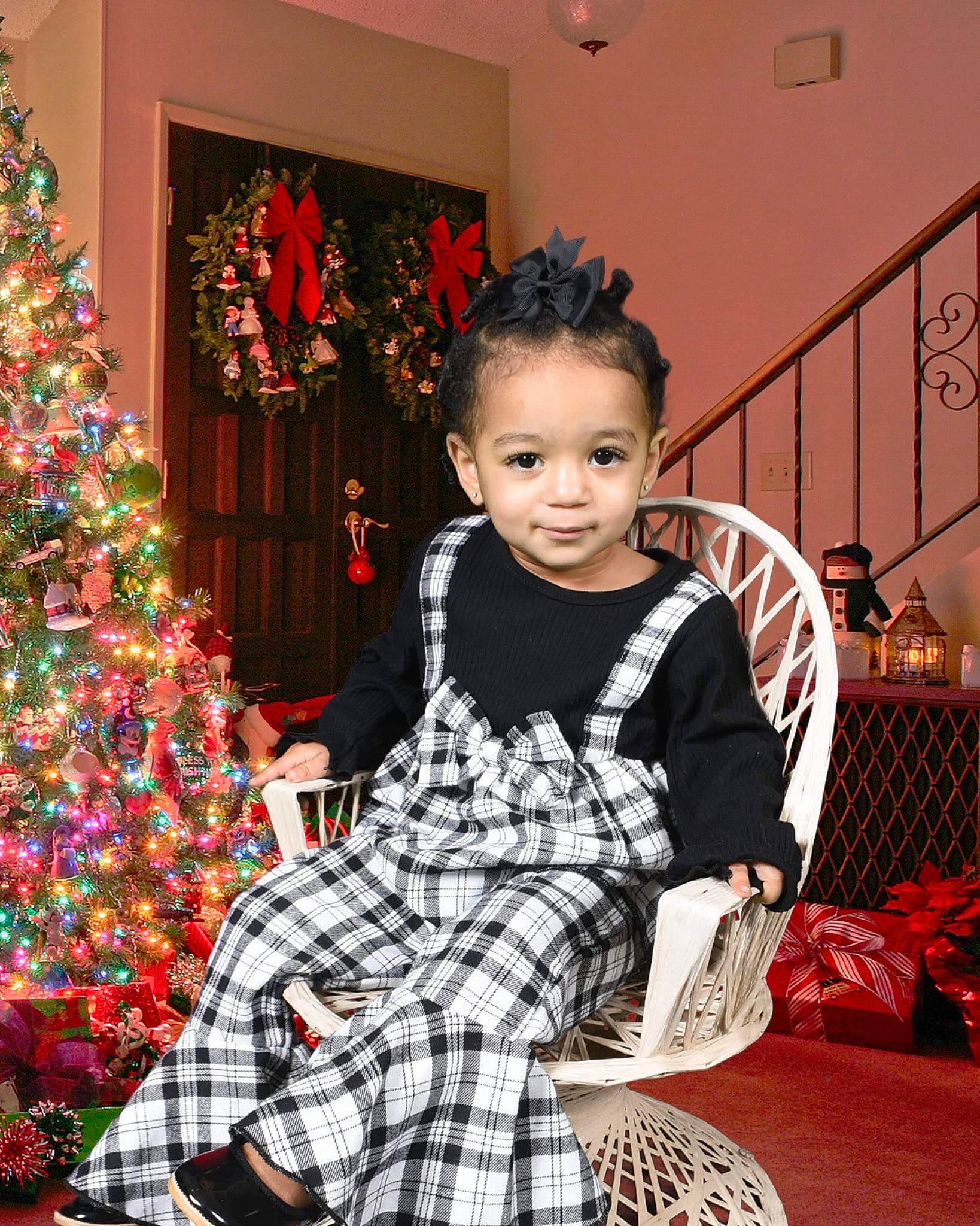 Ellee is registered to the contest to win money with this photo: christmas_ornament, christmas_tree, event, evergreen, fashion_design, formal_wear, happy, holiday, holiday_ornament, ornament, pattern, person, plaid, room, sitting, sleeve, smile, tartan, toddler, tree