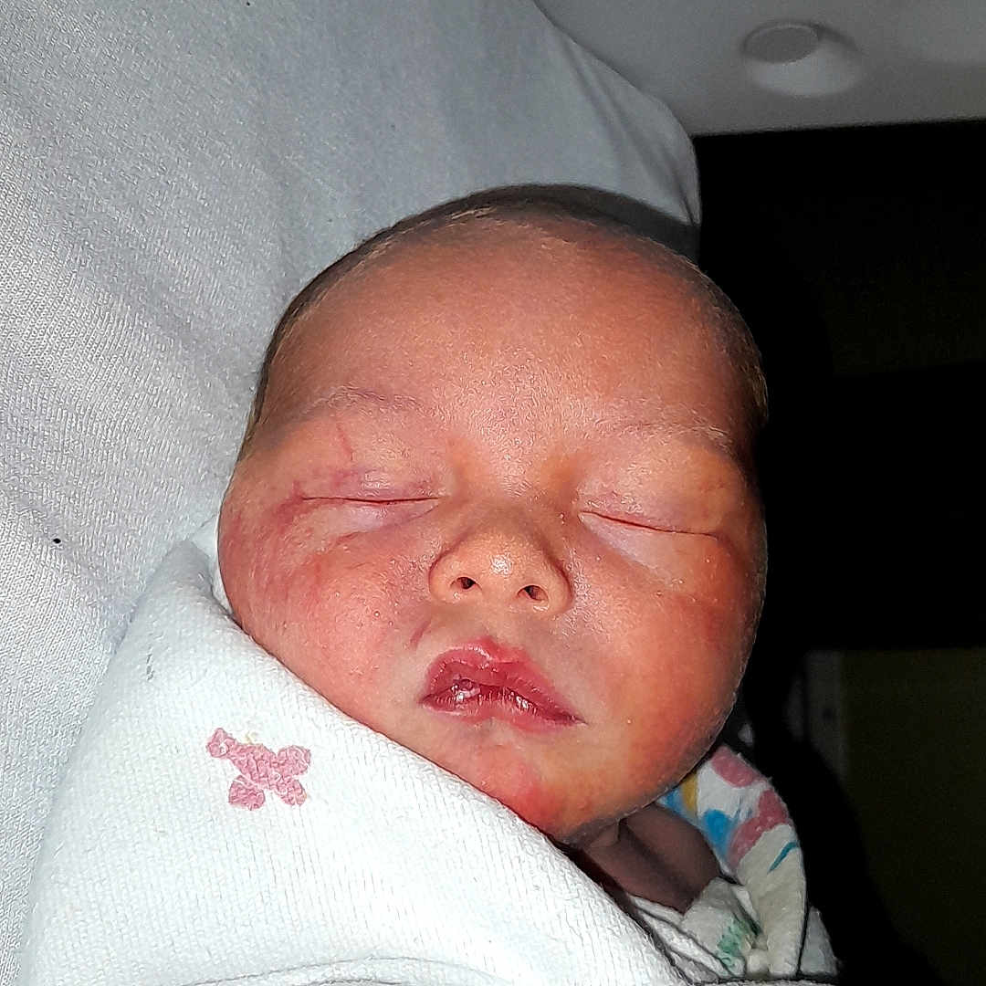 Abraham joined the competition — help win amazing prizes! baby, bed, blanket, clothing, cradle, crib, face, furniture, hat, head, infantbed, newborn, person, photography, portrait, sleeping, towel