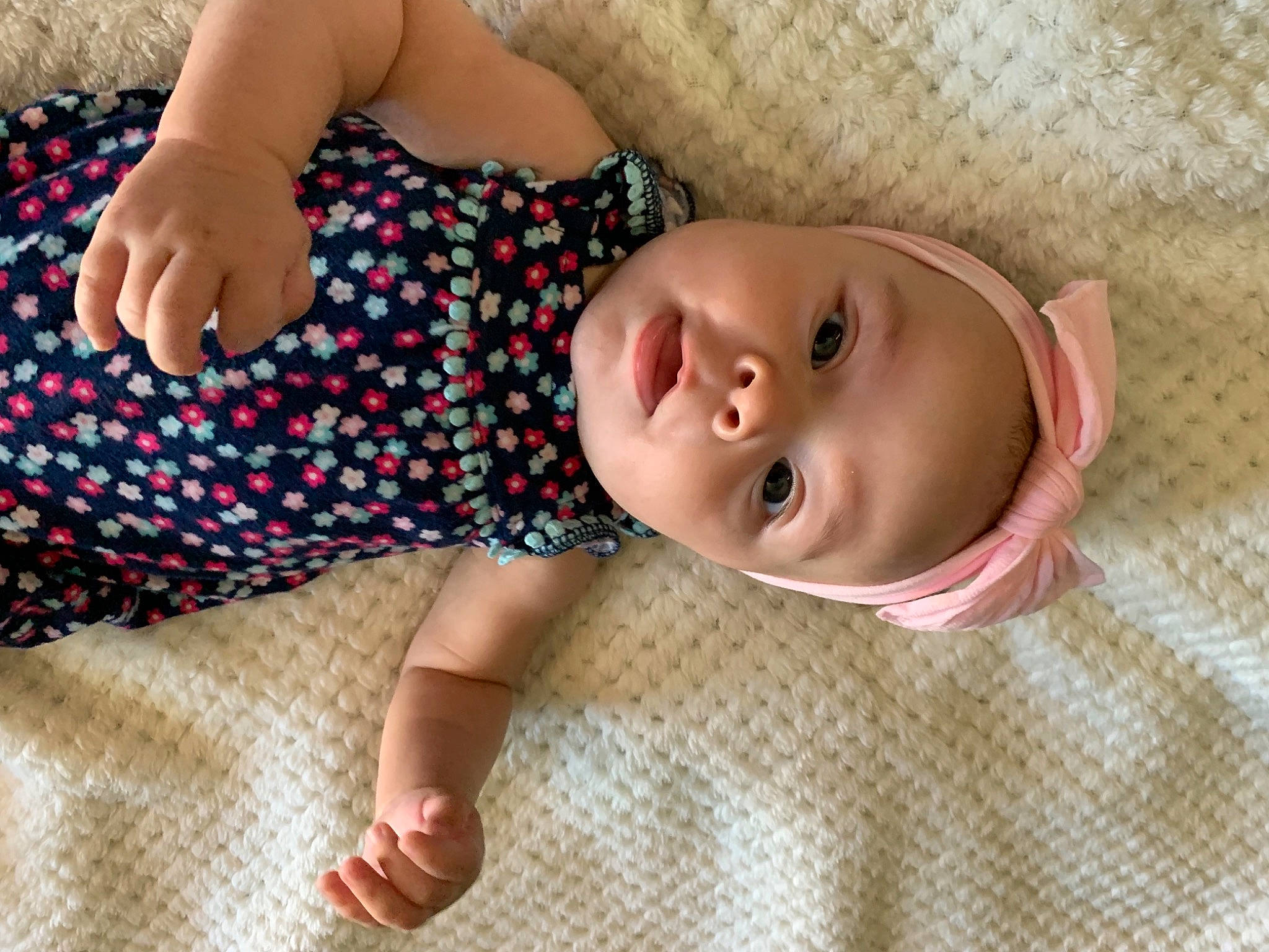 Laylah is registered to the contest to win money with this photo: baby, baby_products, baby_toddler_clothing, cheek, child, comfort, eye, flooring, foot, fun, grass, human_body, linens, nose, pattern, person, skin, sleeve, smile, toddler