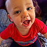 Niko joined the competition — help win amazing prizes! toddler, child, smile, happy, face, blue_eyes, red_shirt, indoor, blanket, pillow, couch, cute, baby, person, portrait, sitting, clothing, young_child, fun, joy